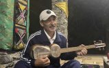 Mr. Komil performs a song in Uzbek or Tajik while playing the country's national instrument, the 