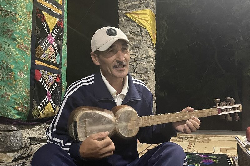 Mr. Komil performs a song in Uzbek or Tajik while playing the country's national instrument, the 
